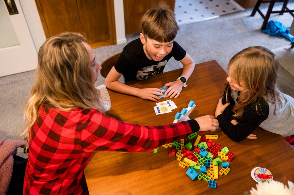 Family playing a game together, son with an excited energetic face